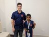 FM Adam C Taylor (coach) presents the iconic ECF silver badge to Kavin prior to round 1